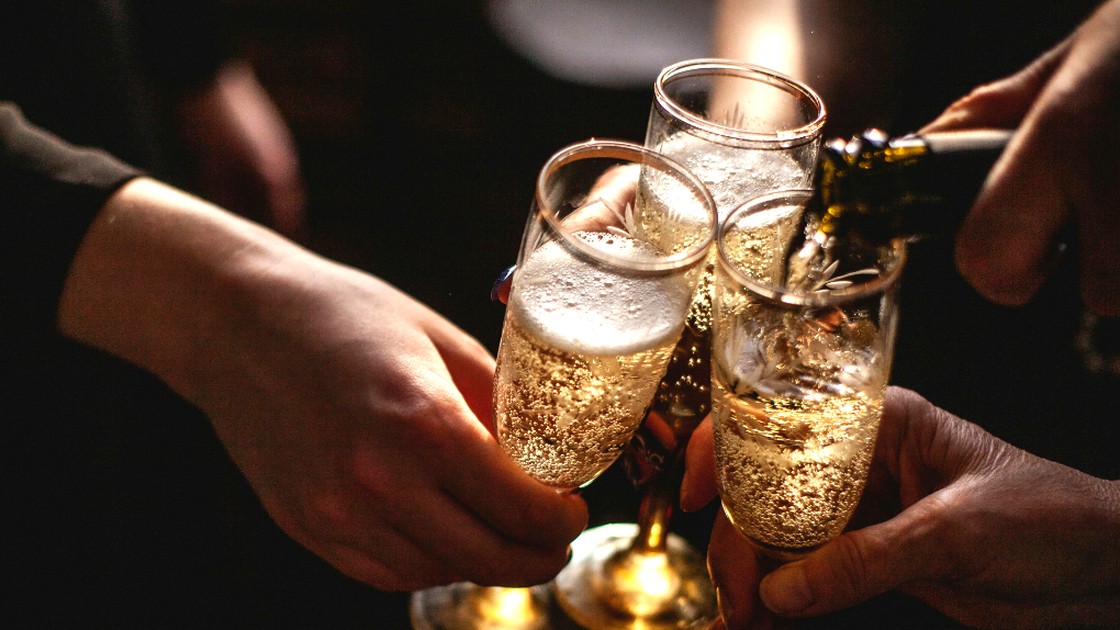 Guests toasting with flutes of Veuve Clicquot champagne at the Champagne Brunch Buffet